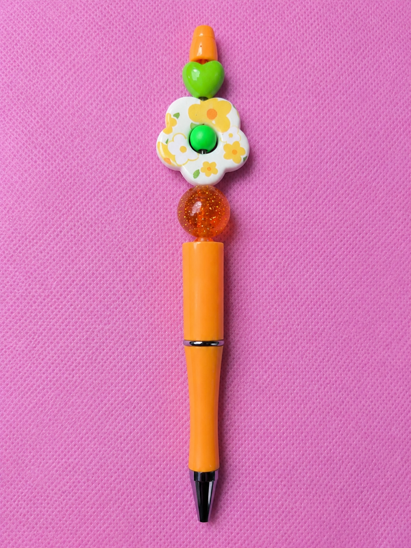 Bolígrafo naranja con flores